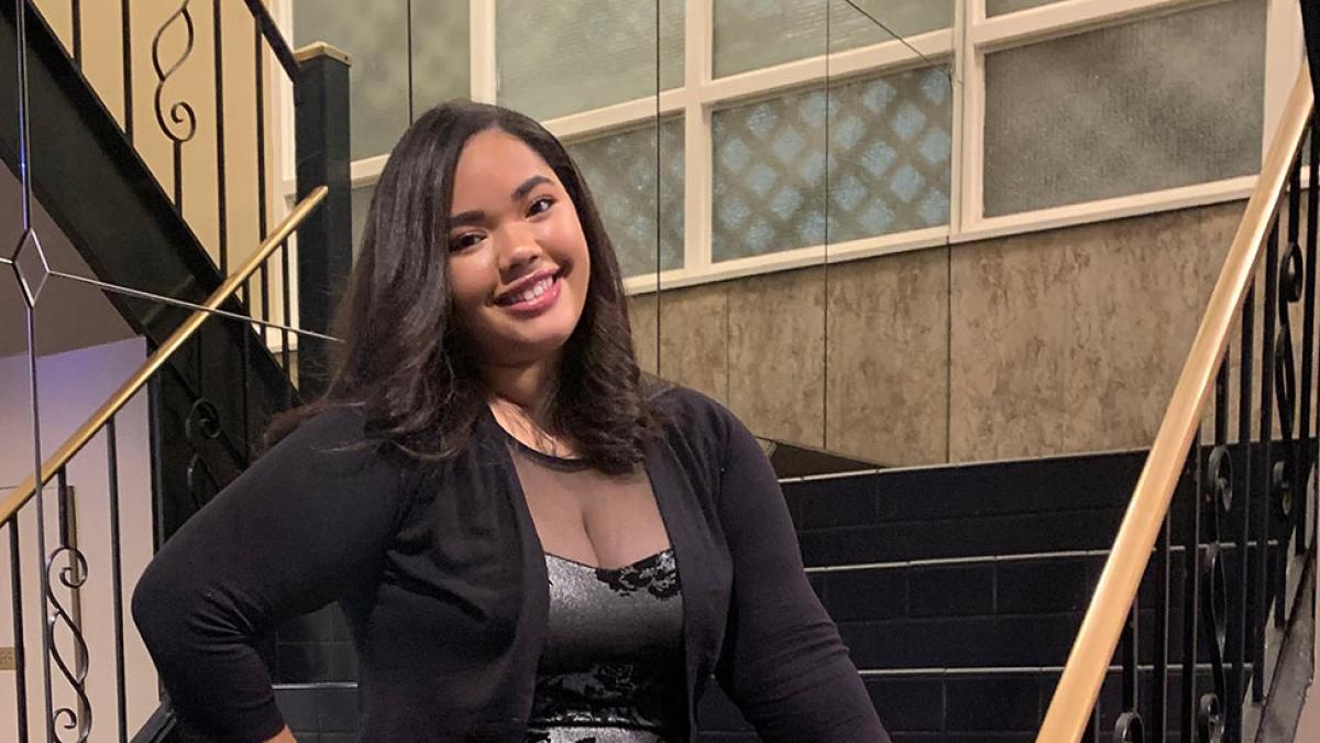 Pace student Valentina Rojas Abreu stands in front of a staircase