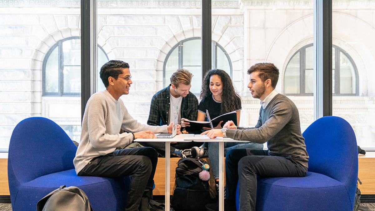 Group of students sitting around a table studying.