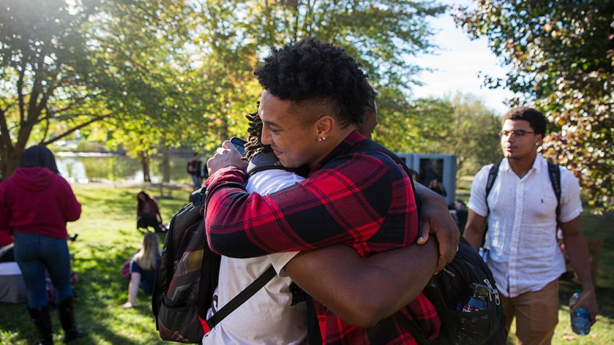 Two pace university students hugging on the Pleasantville campus.