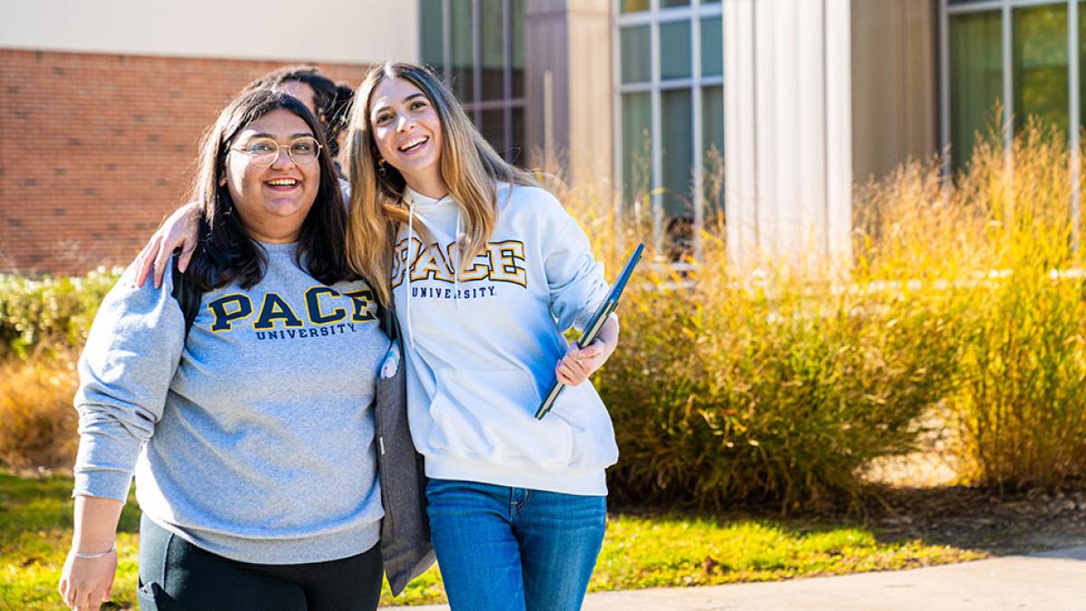Two Pace university students posing for a photo on the Pleasantville campus.