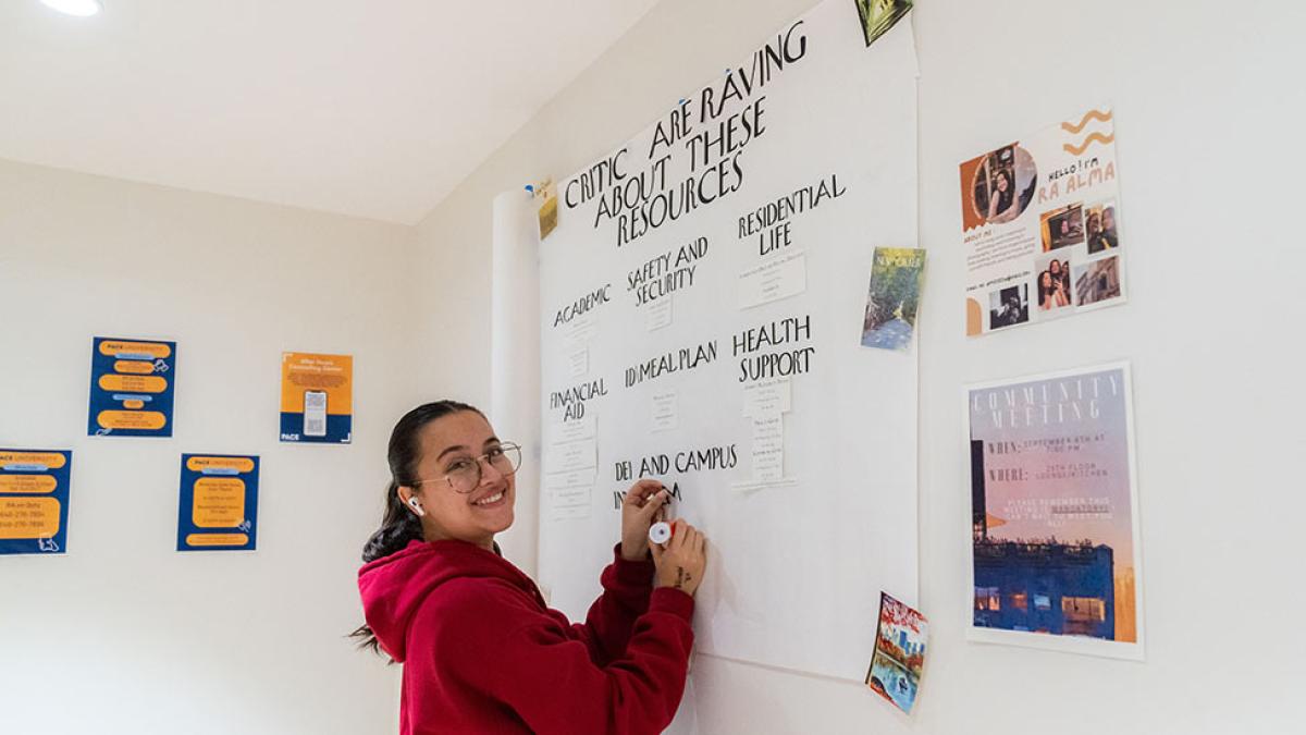 Pace university student writing on a whiteboard