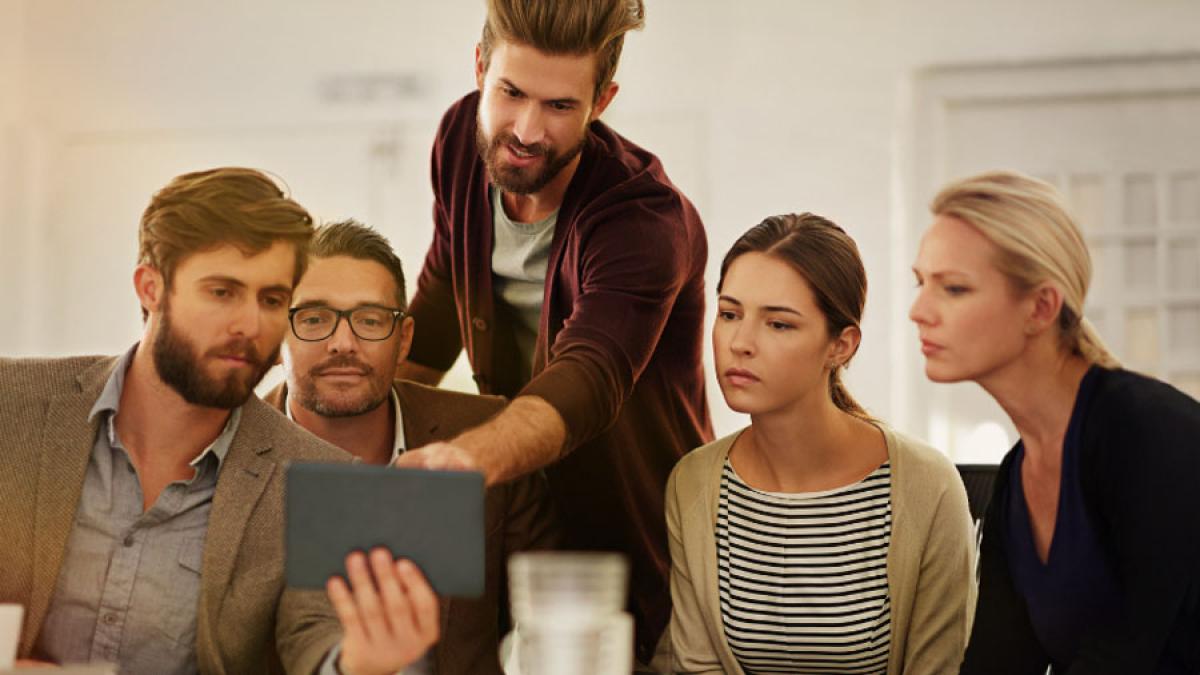 group of people looking at a digital tablet