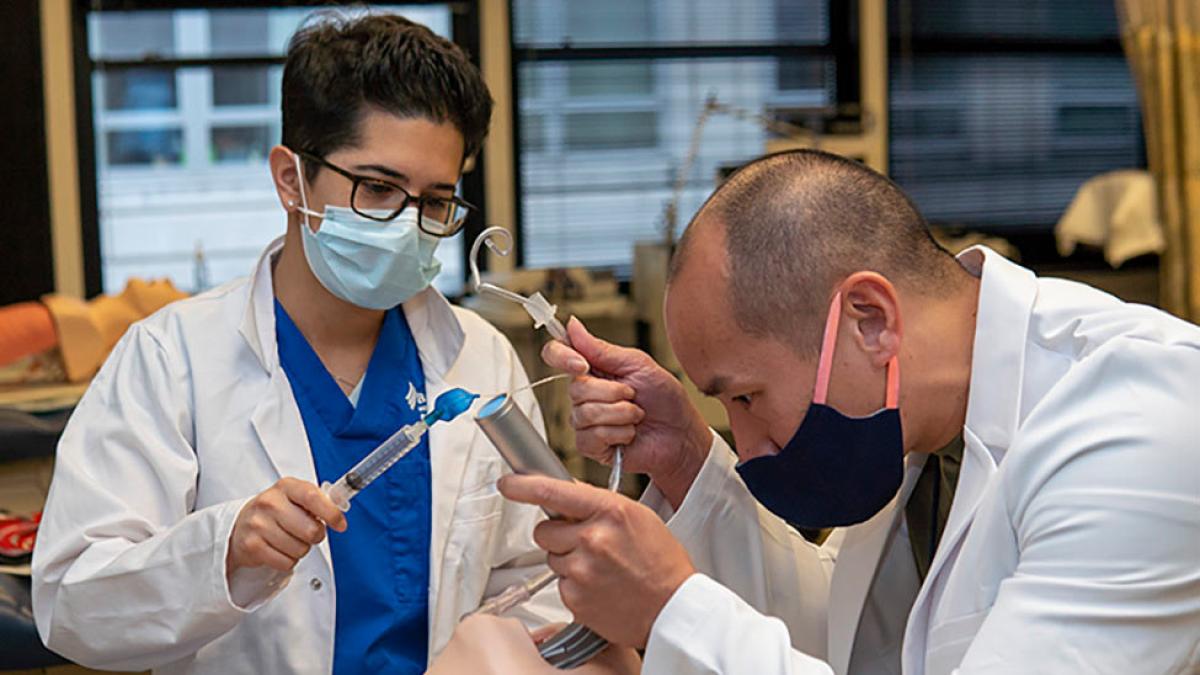 Adult-Gerontology Acute Care Nurse Practitioner students practicing in the lab