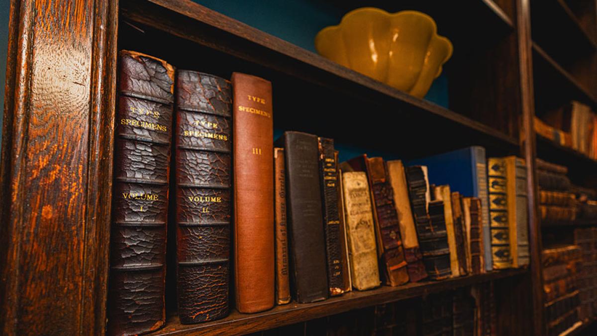 A library shelf full of old, hardcover books