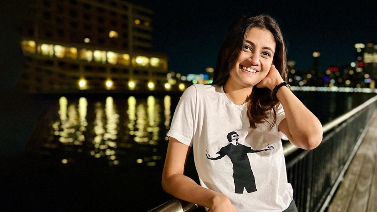 Pace student Shweta Rashmi stands in front of the water at night