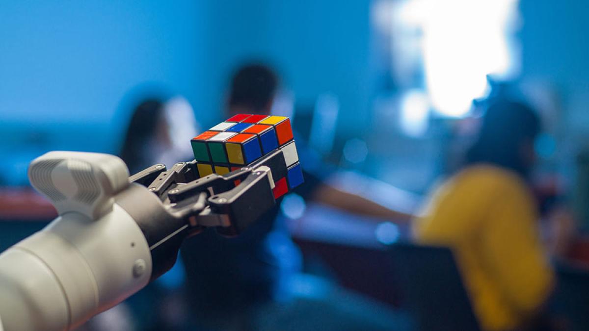 Robotic hand holding a rubics cube