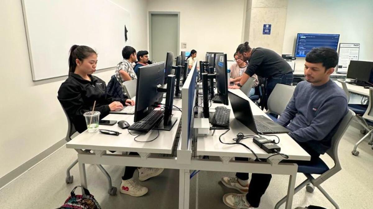 Pace Seidenberg students sitting in front of their computers in the Computational Intelligence Lab during a workshop.