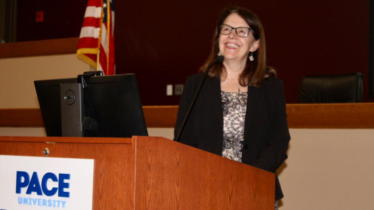 Elisabeth Haub School of Law Visiting Scholar Rebecca Bratspies speaking from podium