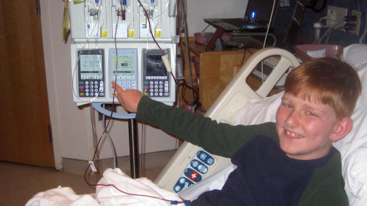 Drew D’Auteuil as a child in a hospital bed.