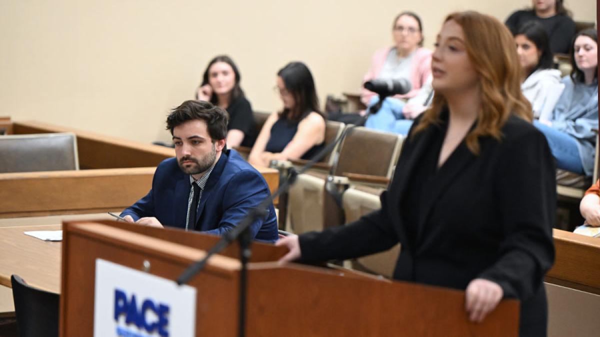 Student speaking at podium during law competition