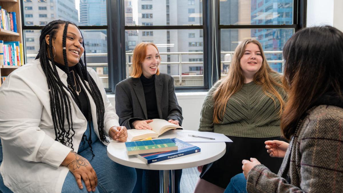 Pace University students talking to each other in a lounge. 
