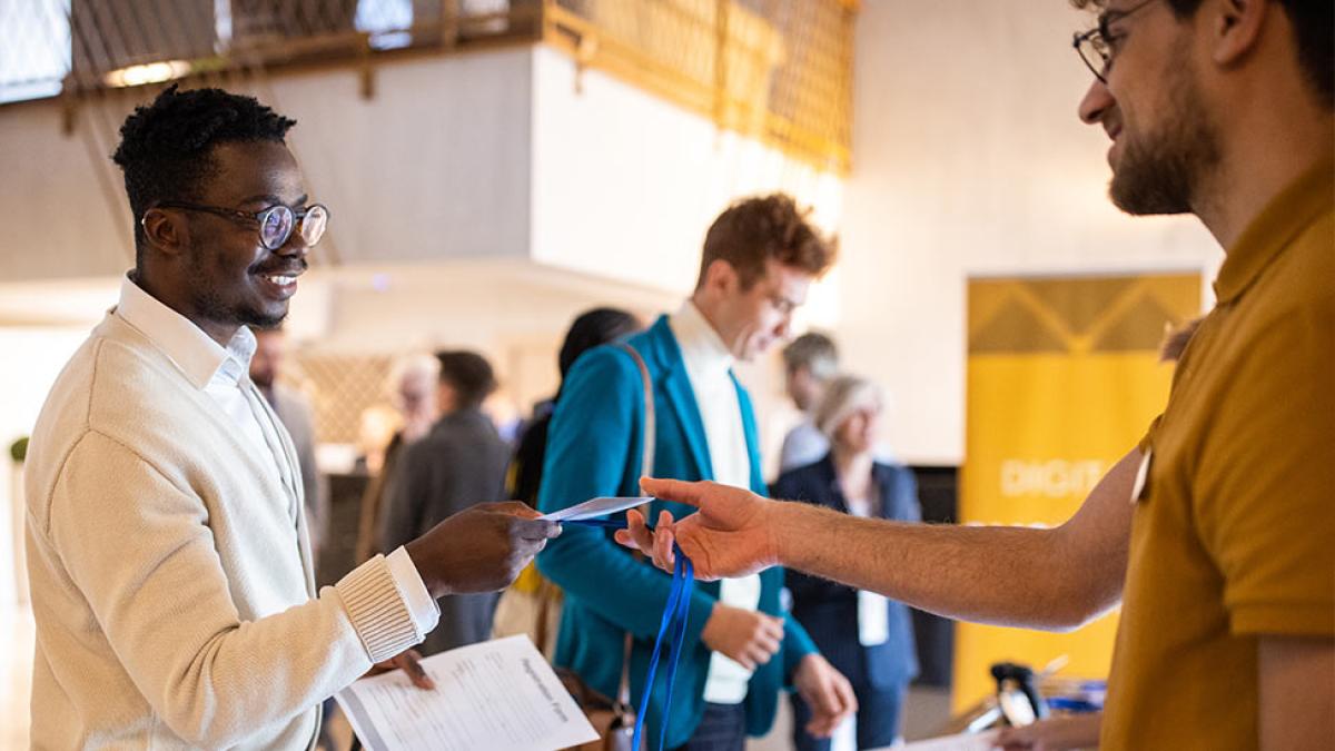 Student receives brochure at a recruitment brochure