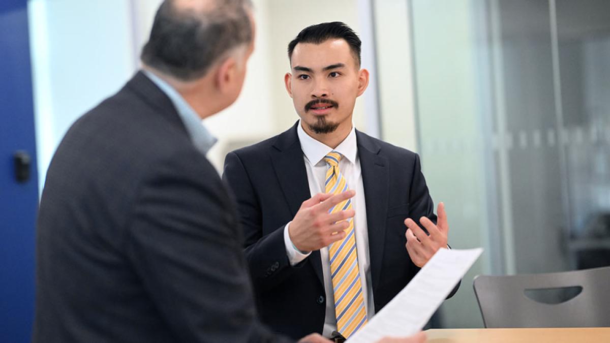 Pace University student speaking with a professor.