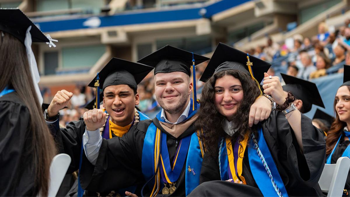 Pace University graduates posing for the camera at Commencement.