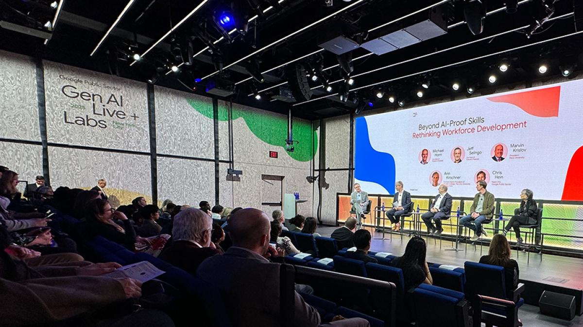 Marvin Krislov on stage with panelists in front of an audience.