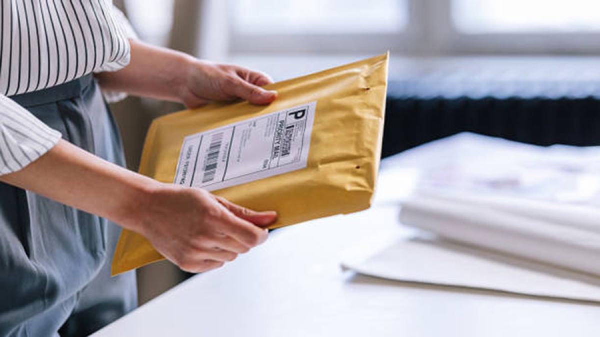 Woman holding a mail package.