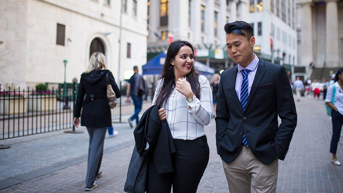 Two Pace University students dressed in business attire, walking around NYC.