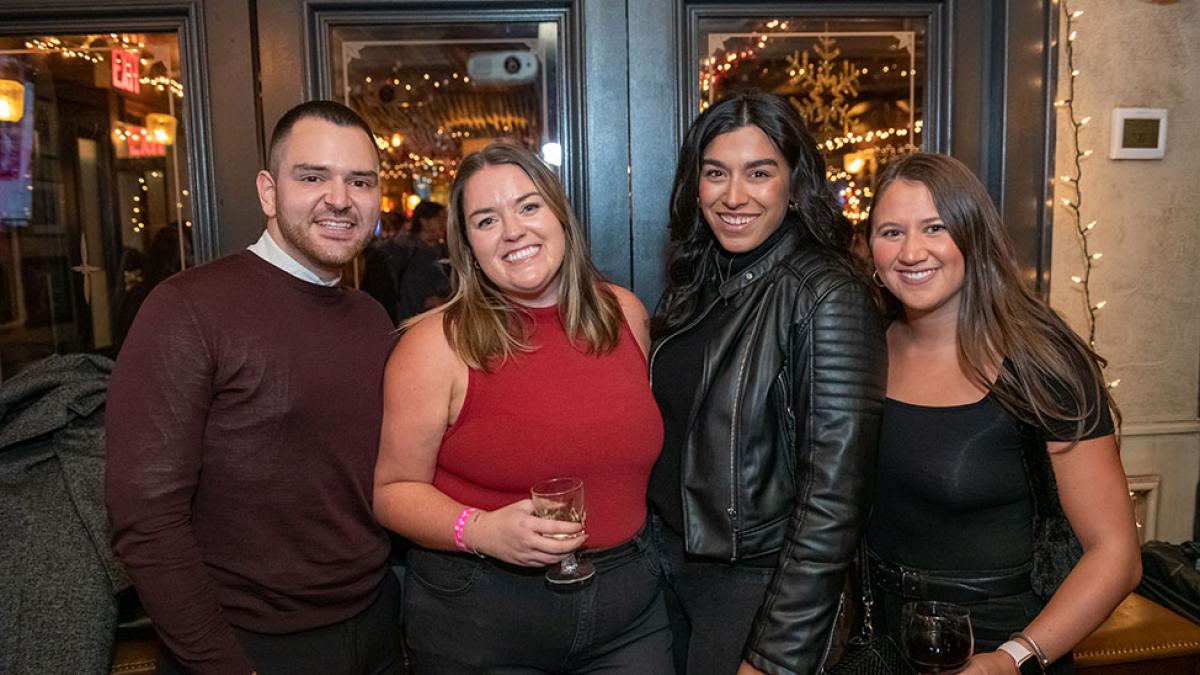 Group of Pace University alumni members of the Gold Committee affinity group, smiling at the camera.
