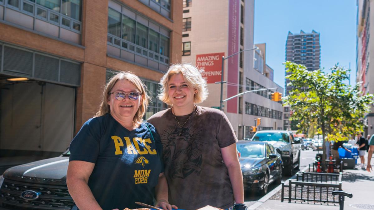 A Pace parent and her student posing outside of 33 Beekman.