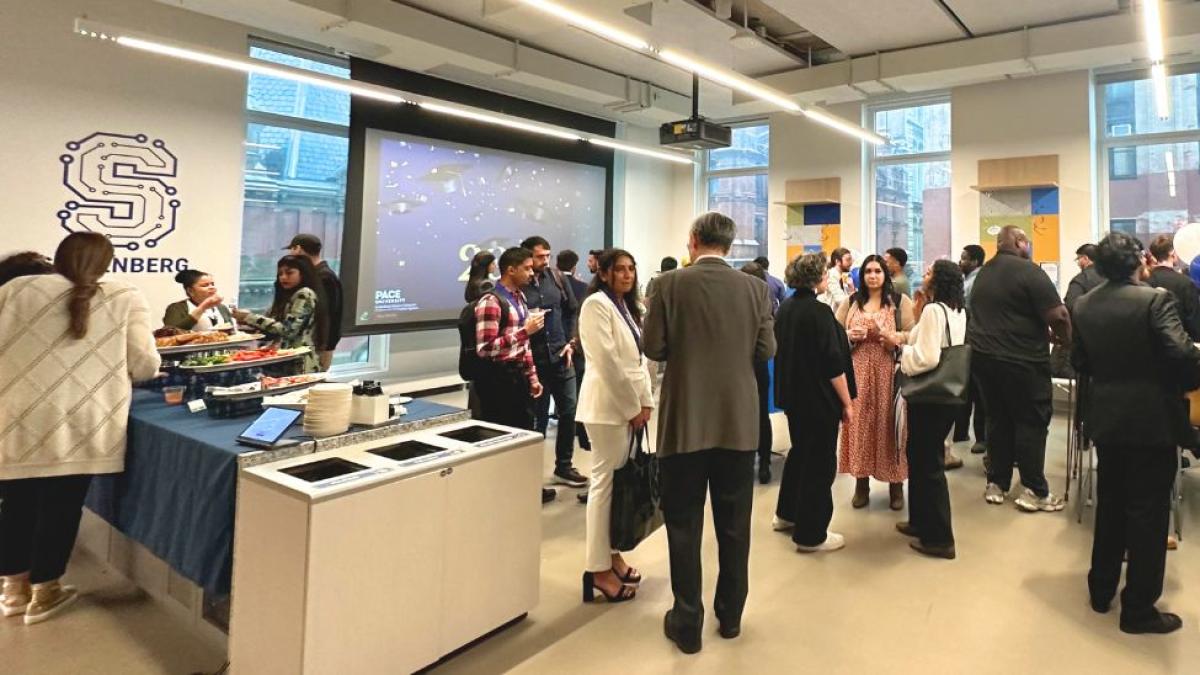 Seidenberg students, faculty, staff, and the students' families mingling in Seidenberg's Design Factory space.