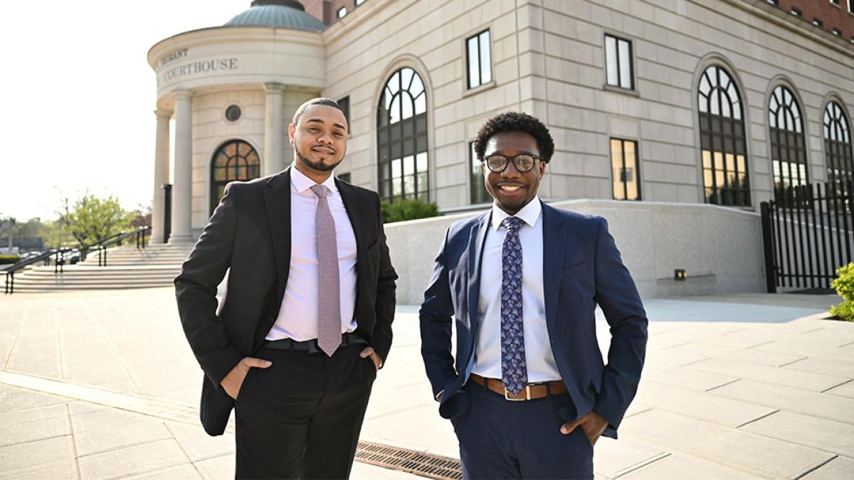 Two Elisabeth Haub School of Law at Pace University students standing outside of White Plains Courthouse in suits