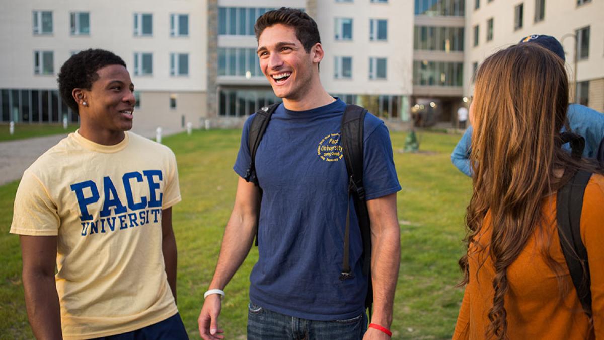 Three Pace University students laughing together on the Pleasantville, NY campus.