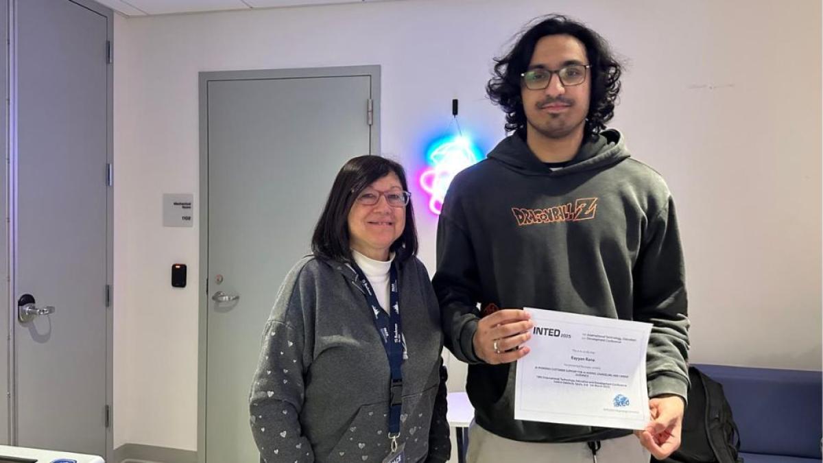 Seidenberg professor Mary Tedeschi posing for a photo with a Seidenberg student who is holding their diploma from the INTED 2025 conference.