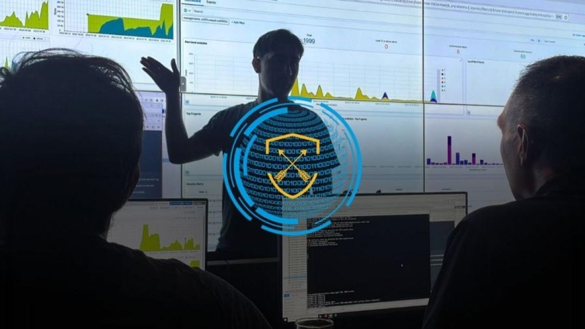 Seidenberg students working in the Pace Cyber Range in front of its giant video wall, with the Cyber Range logo placed over the image.