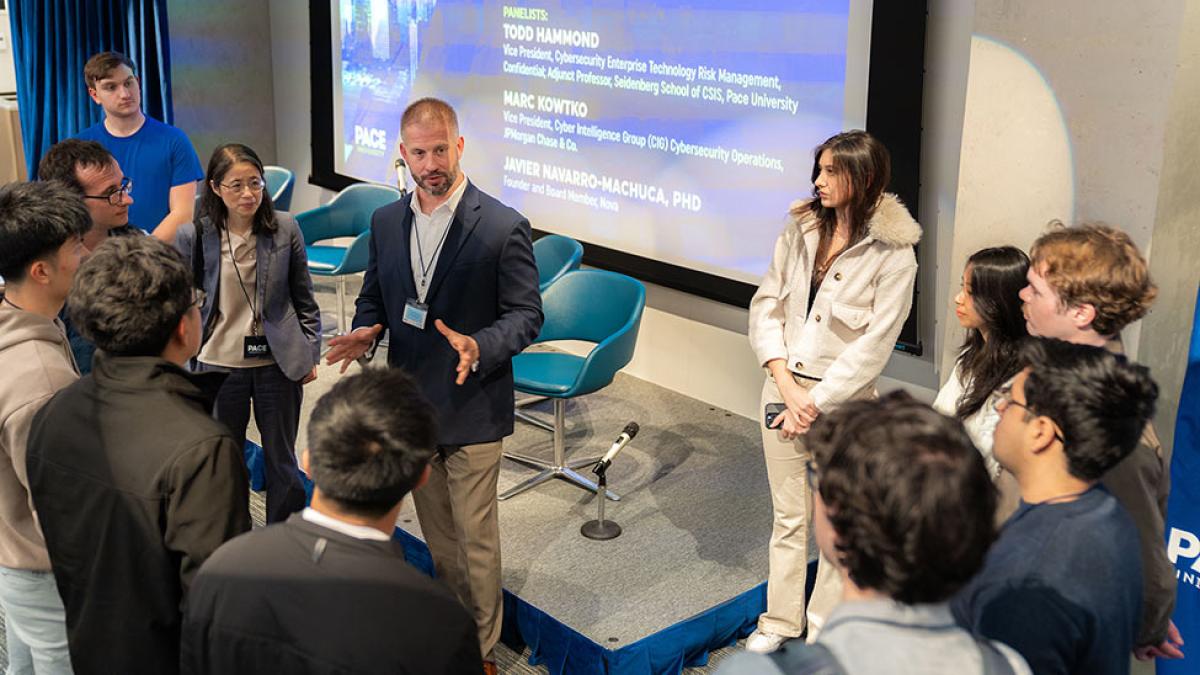 Todd Hammond, an industry executive and adjunct professor at Pace, and Seidenberg interim Dean Li-Chiou Chen speak with students at the Pace of Fintech Conference.
