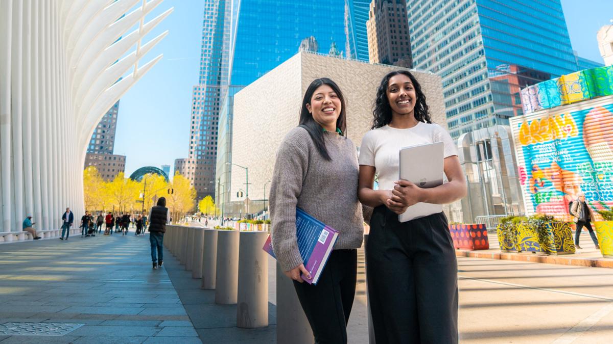 Two Pace students posing near the Oculus.