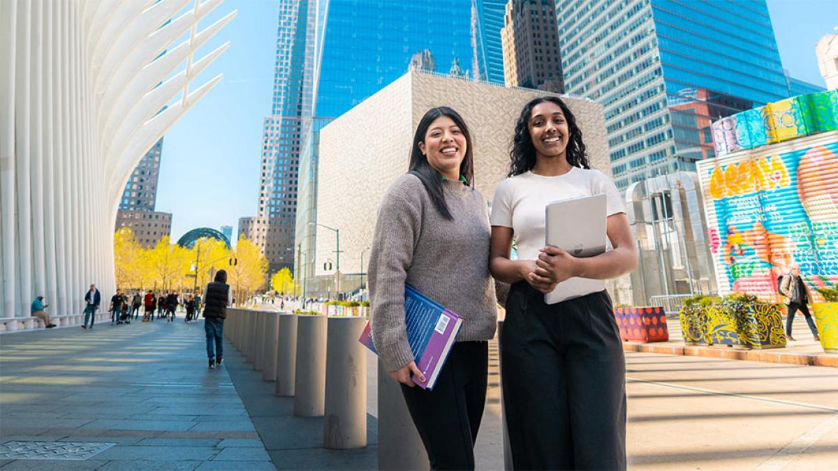 Two Pace students posing near the Oculus.