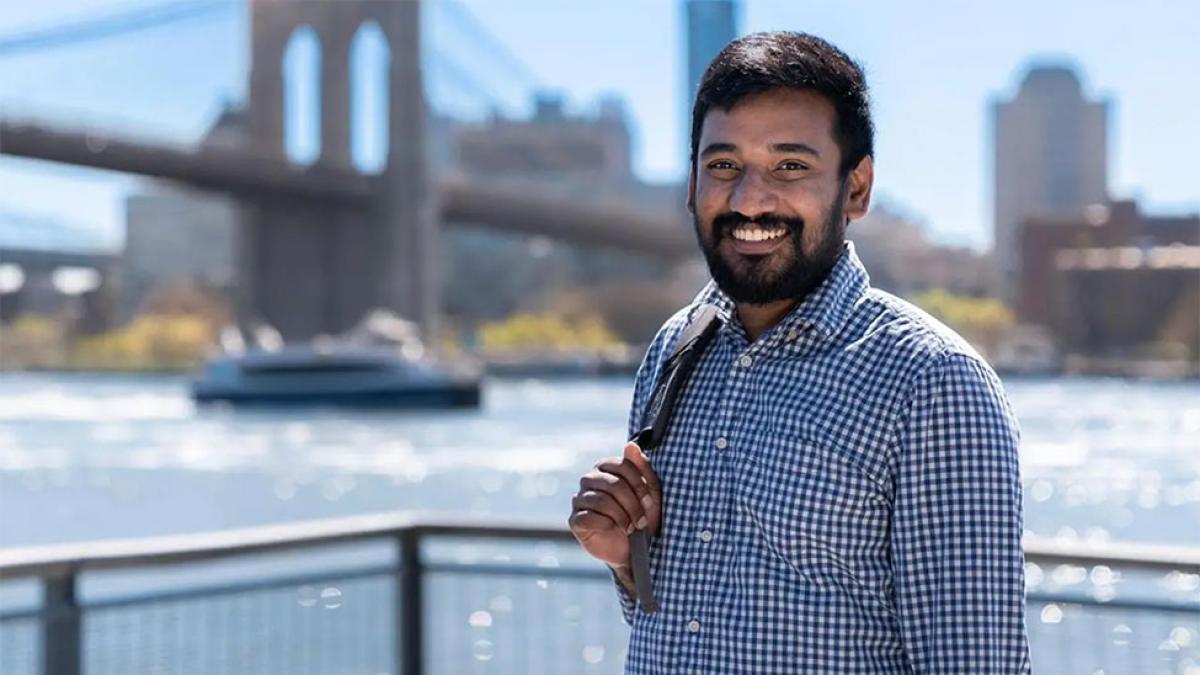 Pace student at the South Street Seaport with Brooklyn Bridge in the background.