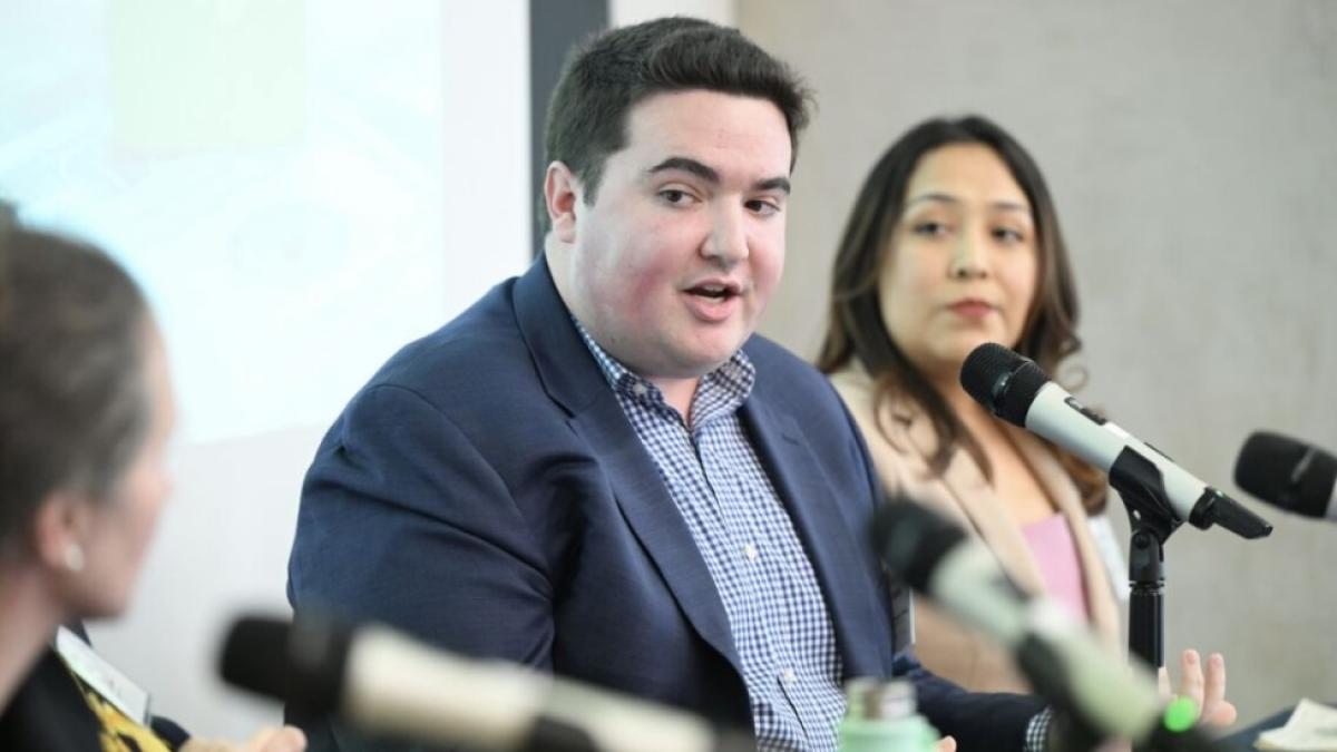 Elisabeth Haub School of Law at Pace University student Harrison Bench '27 speaking in front of a microphone