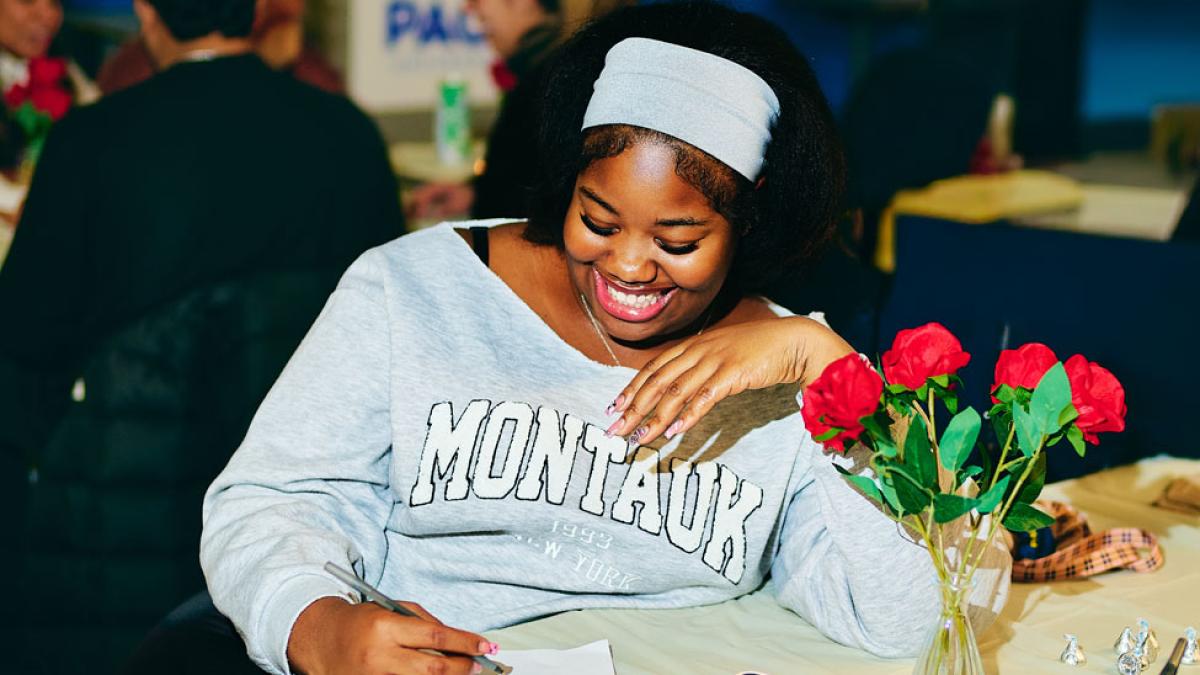 A Pace University student smiles as she engages in a date night activity