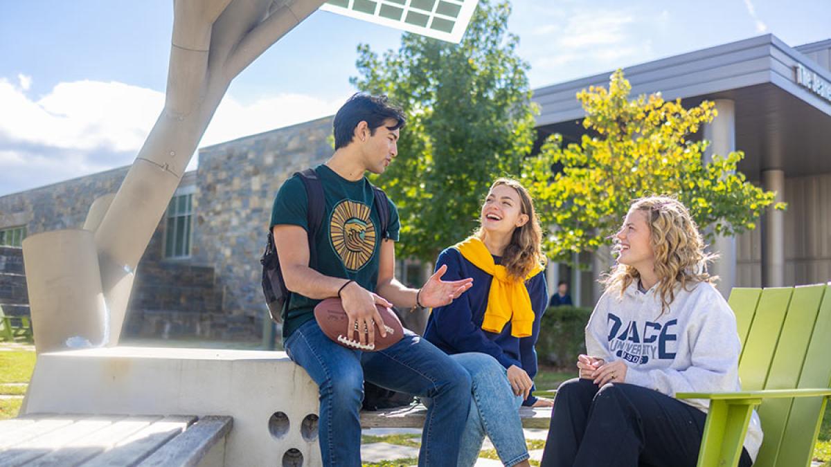 Three Pace University students sit outside on the Westchester Campus