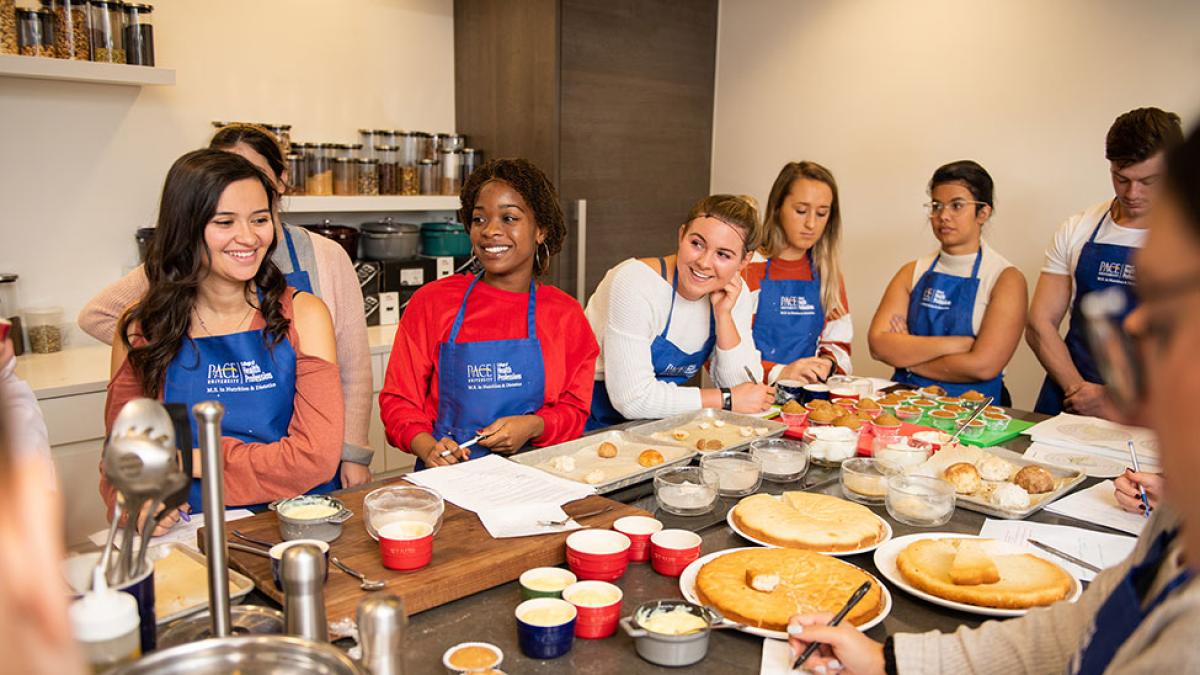Group of Pace University Nutrition and Dietetics students making cupcakes in Pace's test kitchen.