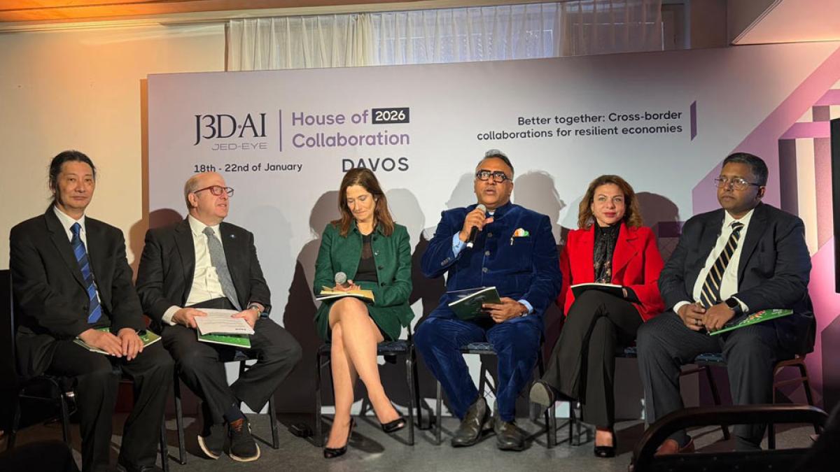 Marvin Krislov on stage with panelists in front of an audience at Davos.