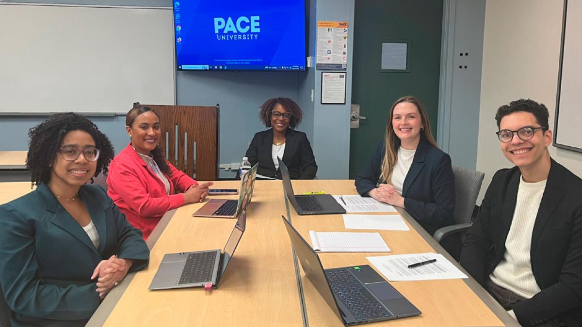 Students and professors at table from Amelia A. Gould Representation in Mediation Clinic at the Elisabeth Haub School of Law