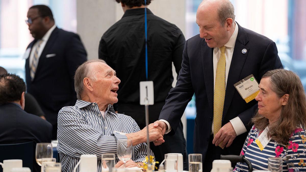 Pace University alumni shaking President Krislov's hand at the Golden Graduates Celebration.