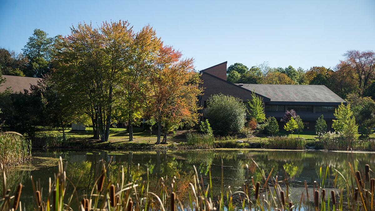 An outdoor shot of the pond and some buildings on the Pace Westchester Campus