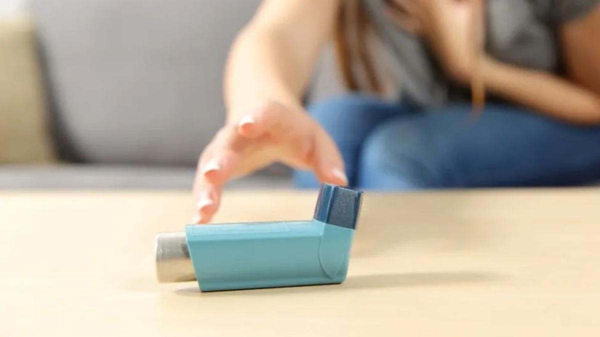 woman reaching for asthma pump
