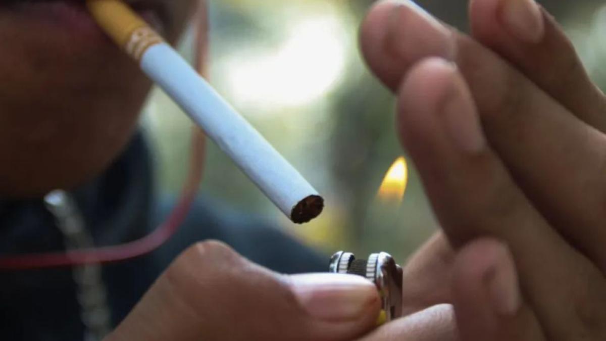 man lighting a cigarette