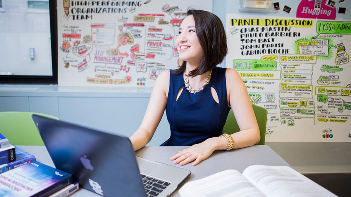 Lubin student sitting at a laptop in a student lounge on the Pleasantville Campus