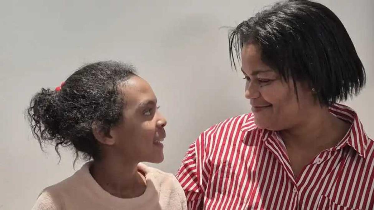 Mother and daughter looking at each other and smiling.