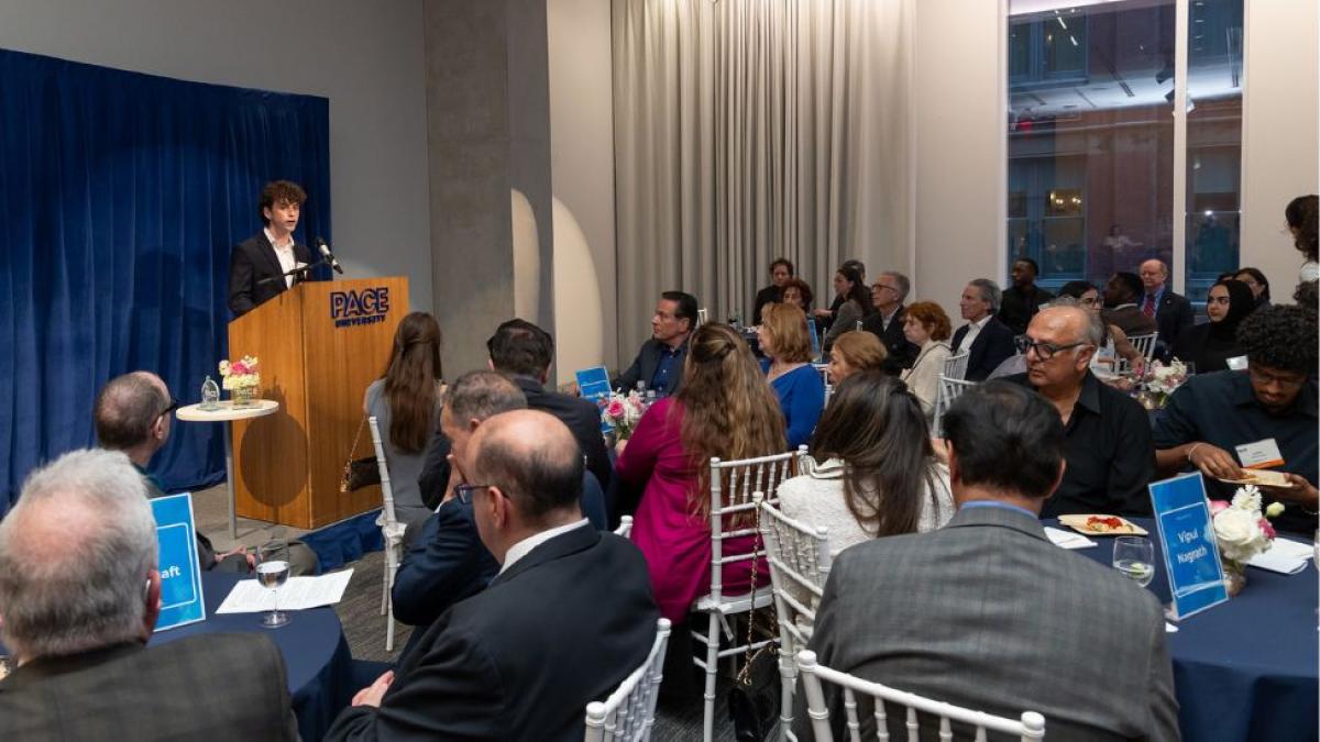 Guests seated at 2026 Seidenberg Innovation Awards as student gives opening remarks