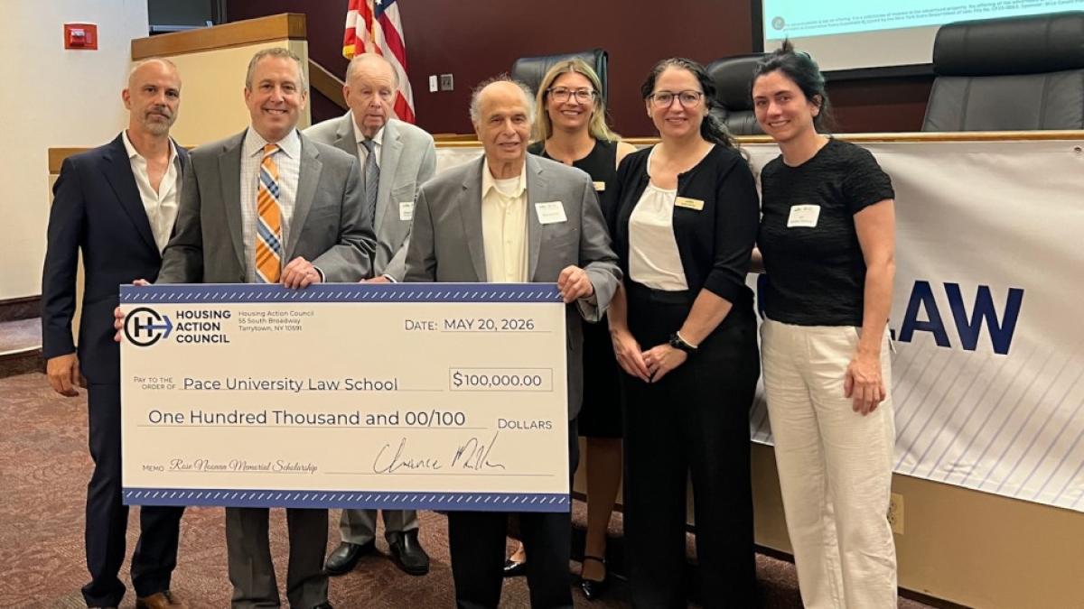 Land Use Law Center team and donors pose with large donated check