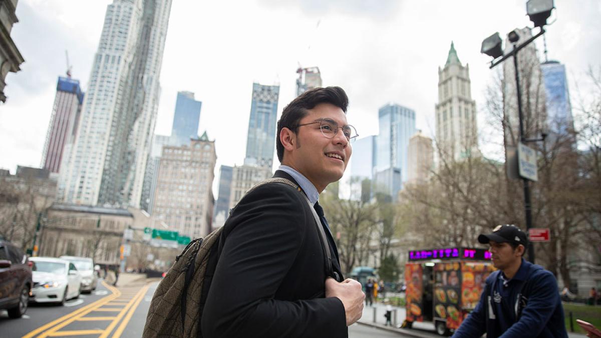 Pace University student dressed in a suit walking around NYC.