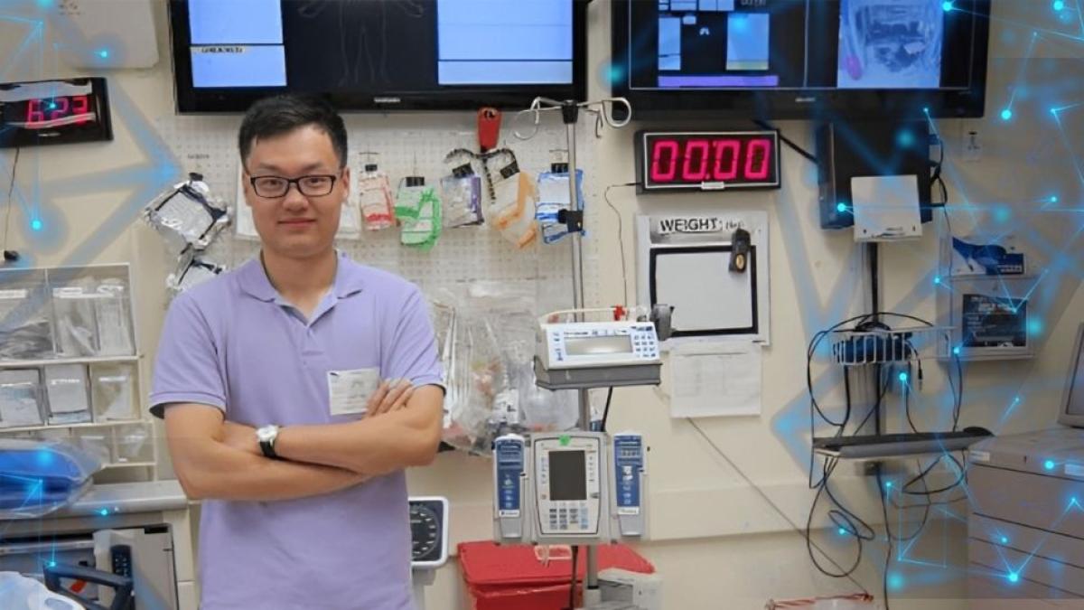 Seidenberg professor Zhan Zhang posing in front of medical equipment