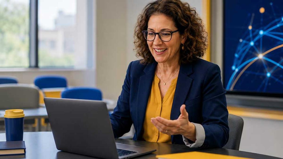 A faculty member working at a computer.