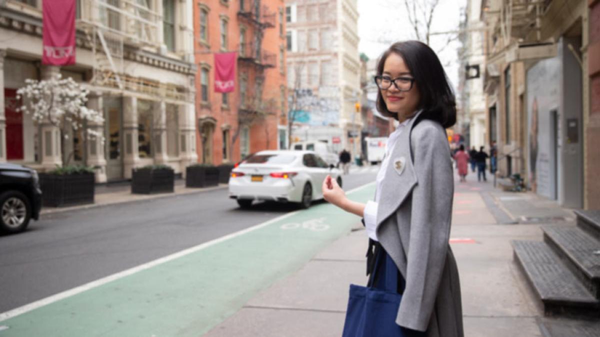 Graduate student walking near teh NYC campus